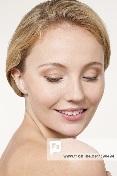Nude Caucasian woman looking over shoulder