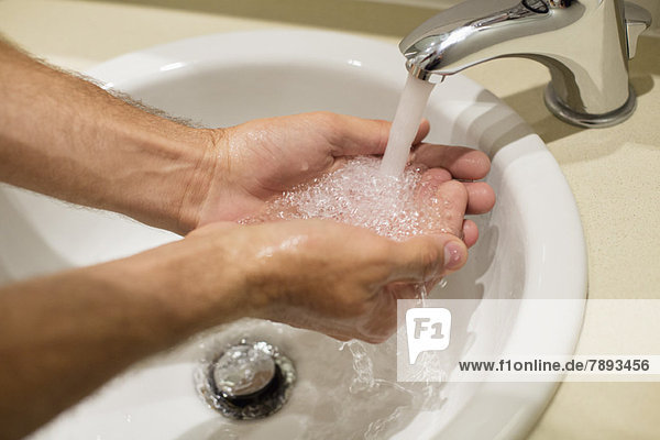 Nahaufnahme eines Mannes beim Händewaschen