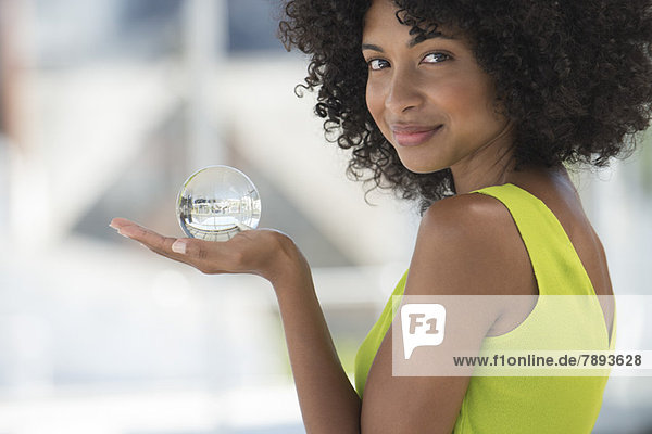 Portrait of a woman holding a crystal ball