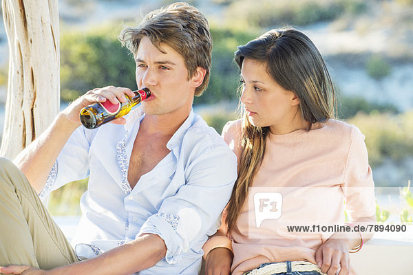 Couple enjoying beer outdoors on a vacation