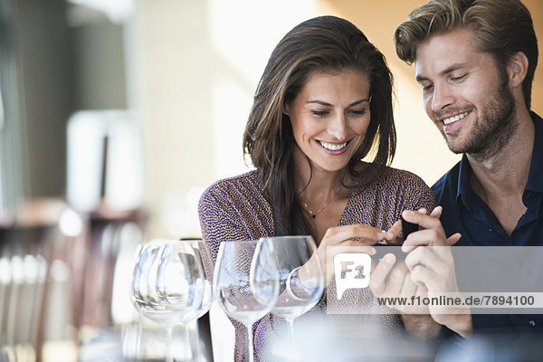 Man giving engagement ring to his girlfriend in a restaurant