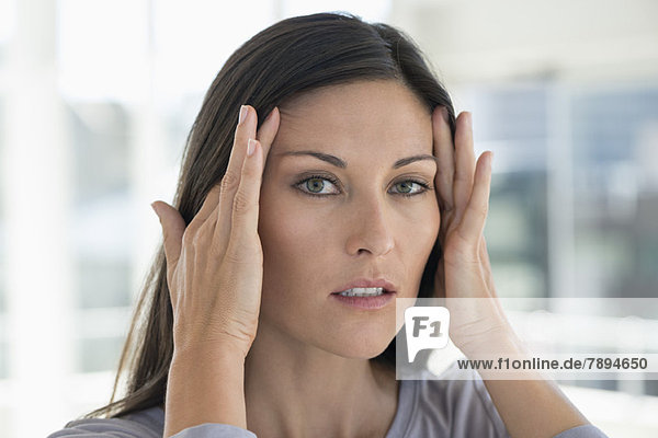 Portrait of a woman suffering from a headache