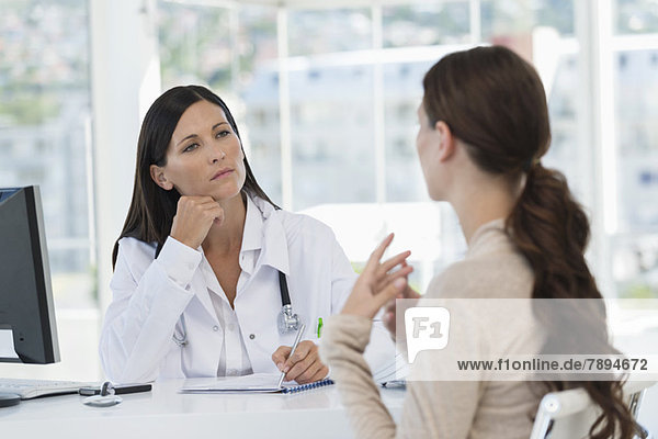 Female doctor discussing with a patient