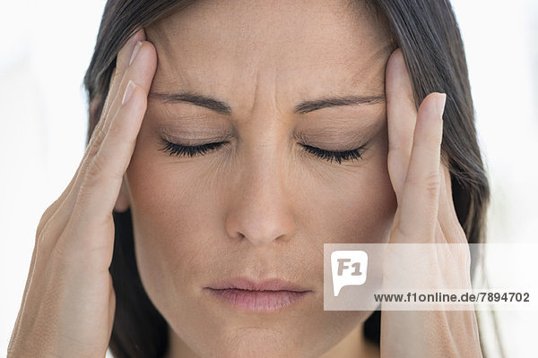 Close-up of a woman suffering from a headache