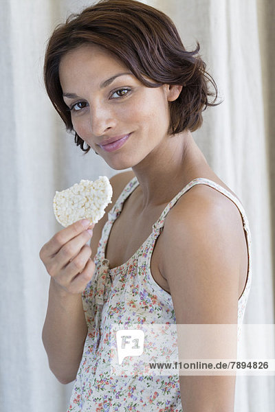 Portrait of a woman eating rice cake