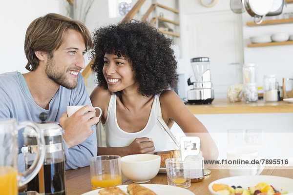 Couple sitting at a dining table having breakfast