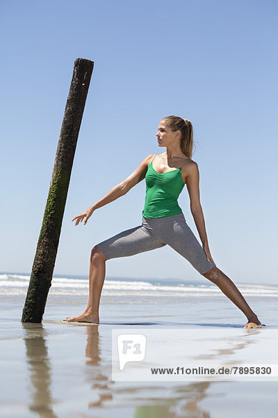 Woman exercising on the beach
