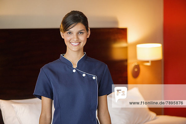 Porträt eines lächelnden Dienstmädchens im Hotelzimmer