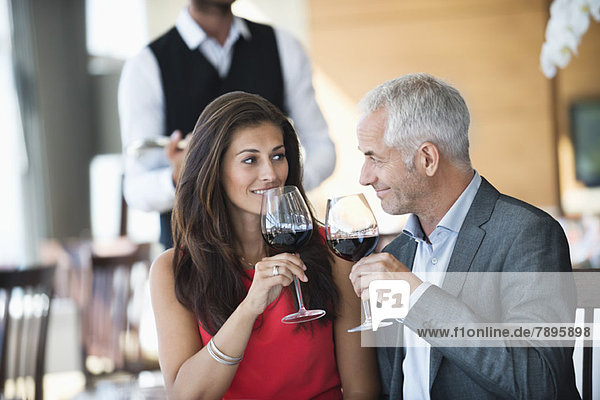Couple enjoying red wine in a restaurant