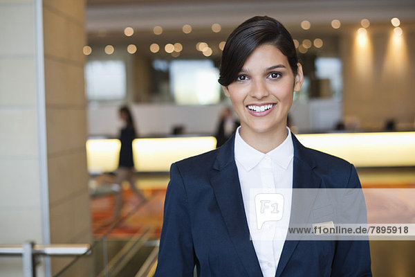 Portrait of a receptionist smiling in a hotel lobby