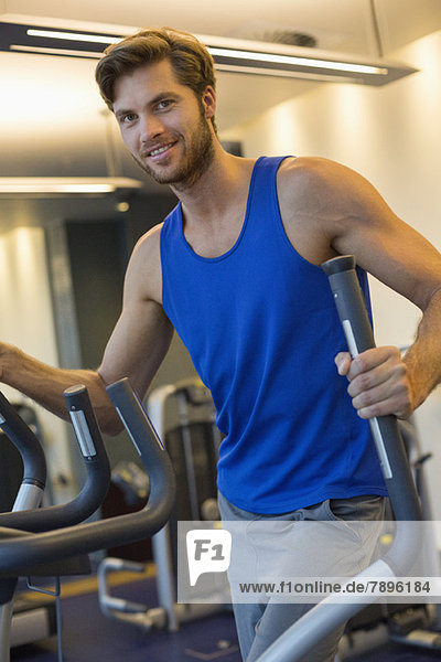Portrait of a smiling man exercising in a gym