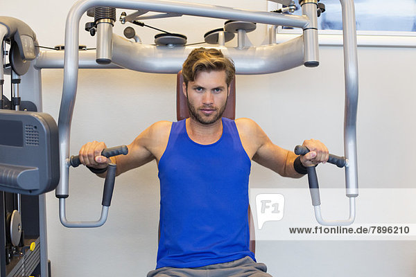 Portrait of a man exercising in a gym