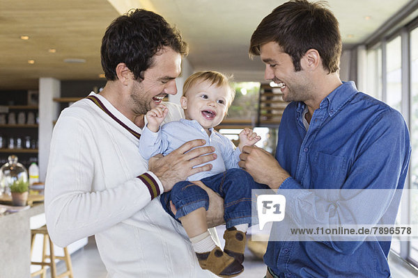 Parents smiling with their son at home