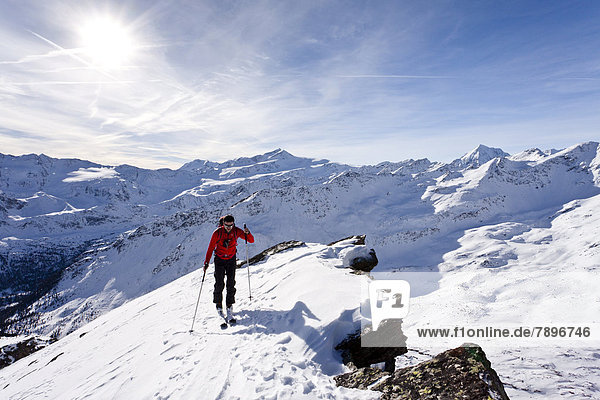 Cross-country skier ascending the Kalfanwand Mountain  Martello Valley below and the Venezia  Zufallspitze  Koenig und Ortler Mountains at the rear