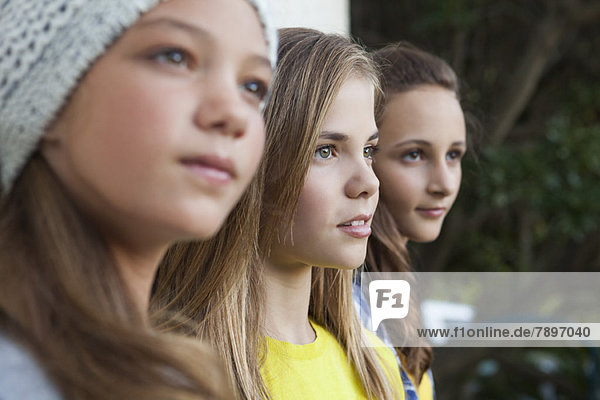 Close-up of three girls staring