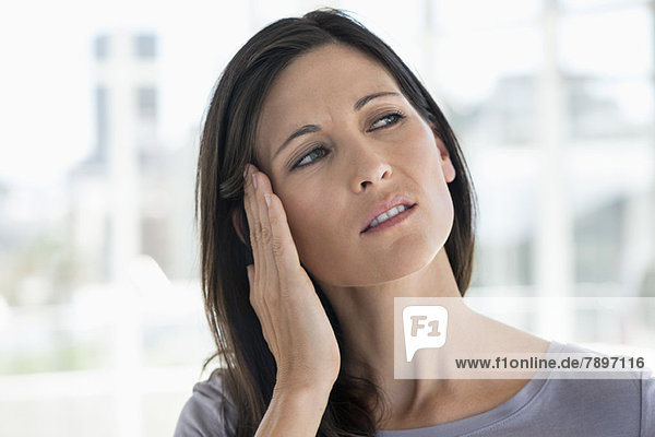 Woman suffering from an ear ache