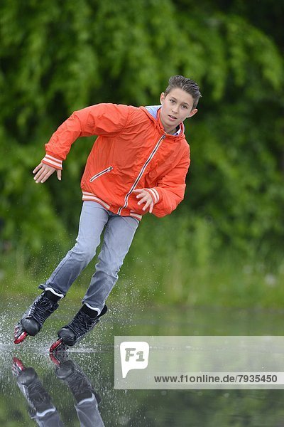 Boy with in-line skates on a rainy day
