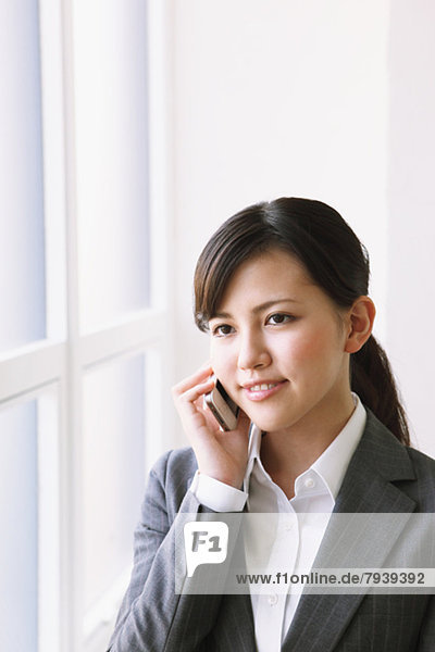 Businesswoman on the phone by the window