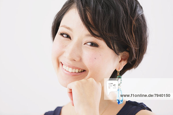 Young woman with earrings smiling at camera