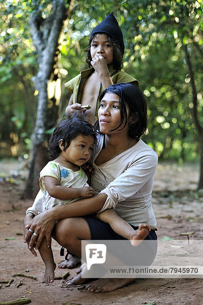 Young mother with two girls in the community of Mbya-Guarani Indians