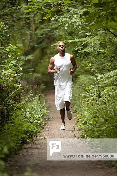 Young african american man trail running