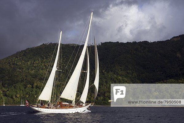 A classic yacht sails along the coast of St. Lucia.