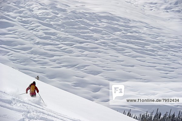 A woman skis above a glacier.