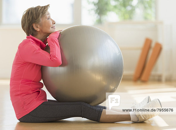 Senior woman exercising with fitness ball