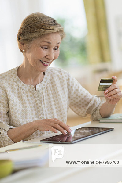 Senior woman shopping online with tablet pc
