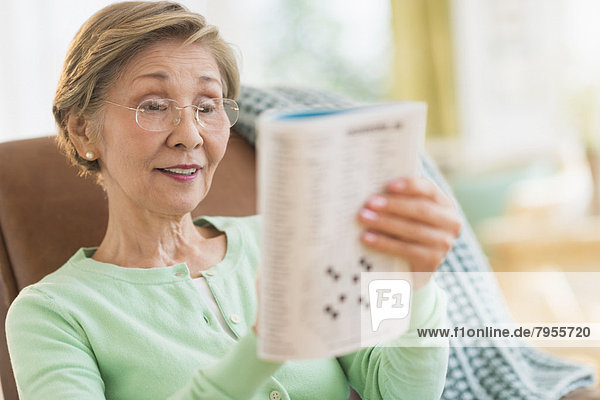 Senior woman doing crossword puzzle