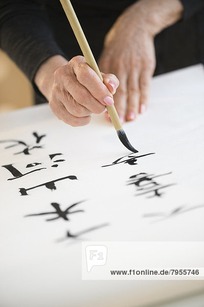 Female hands and japanese calligraphy