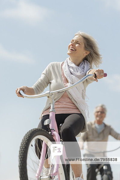 Senior couple riding bicycle