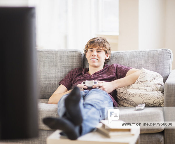 Teenage boy (14-15) playing video game