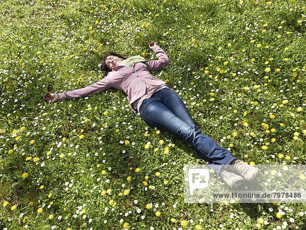Mature women lying on meadow