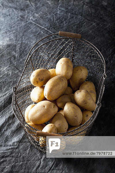 Raw potatoes in basket  close up