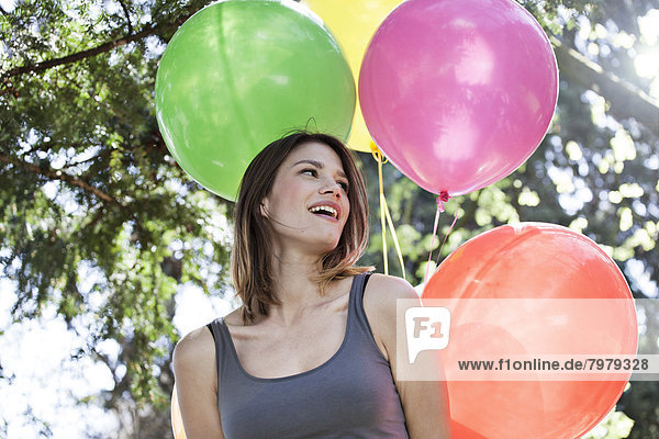 Young woman with balloons  smiling