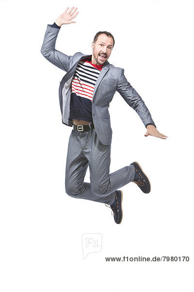 Mature man jumping against white background