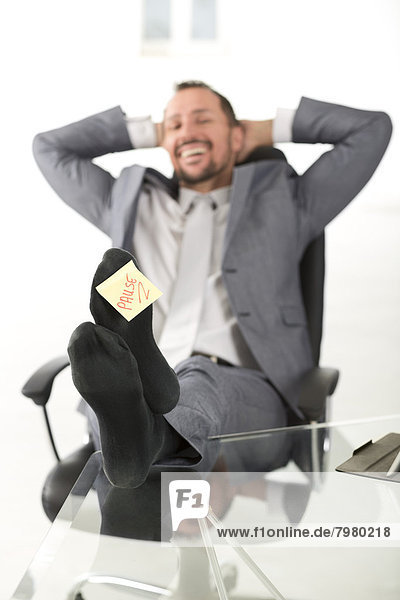 Germany  Portrait of businessman sitting relaxed