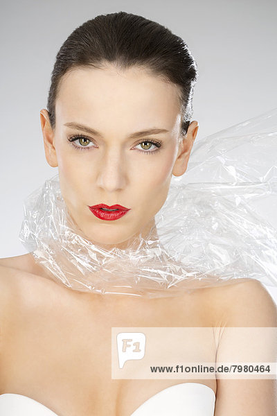 Portrait of young woman wearing plastic foil  close up