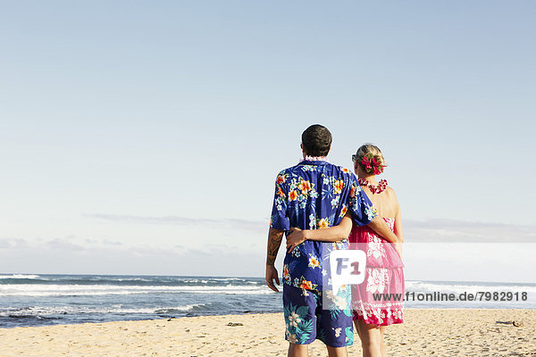 USA  Hawaii  Mid adult couple standing on beach