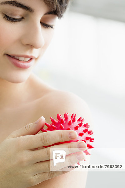 Young woman massaging with massage ball  smiling