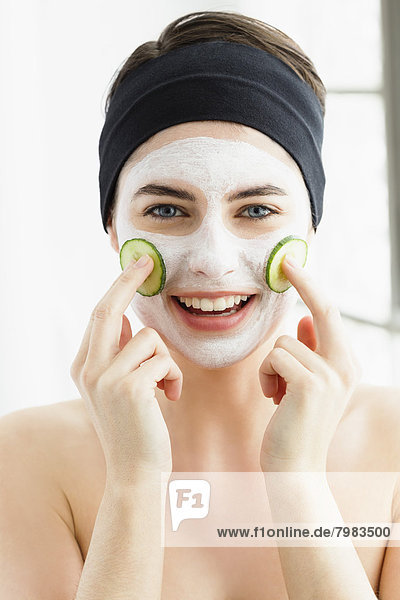 Portrait of young woman with cucumber mask  close up