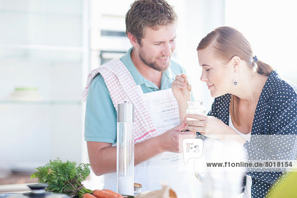 Young couple smelling ingredients
