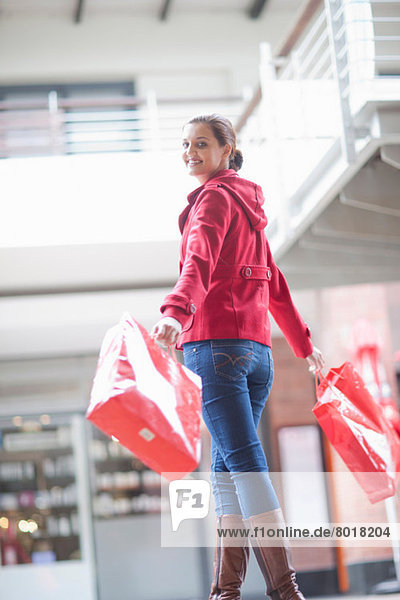 Young woman carrying shopping bags