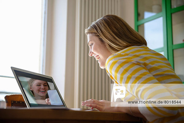 Young woman on video call with friend