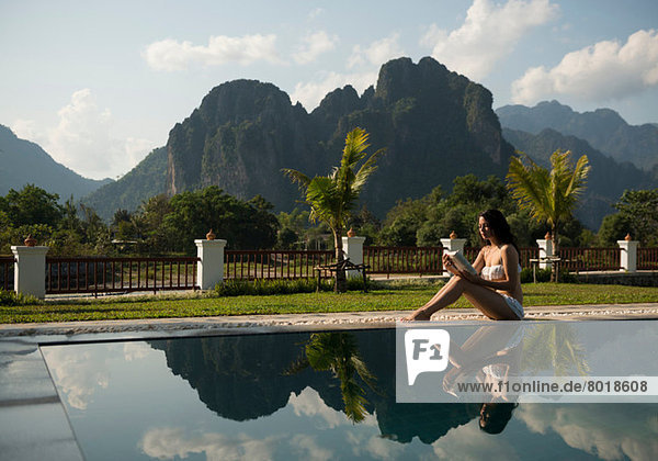 Woman sitting on poolside  Vang Vieng  Laos