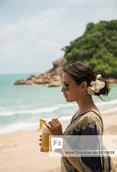 Woman with drink on beach  Banyon Tree Resort  Ko Samui  Thailand