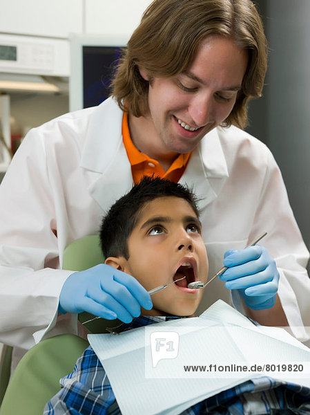 Dentist looking into boy's mouth