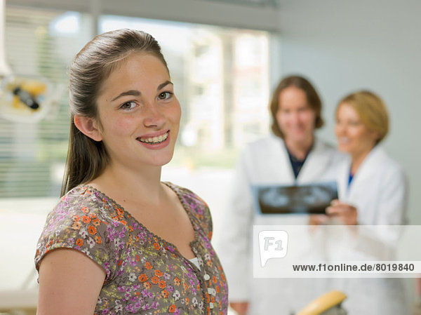 Young woman smiling in dentist's office  portrait