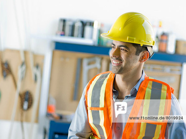 Mid adult construction worker smiling
